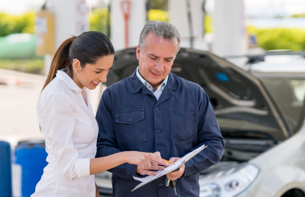 Woman talking to a mechanic about her car