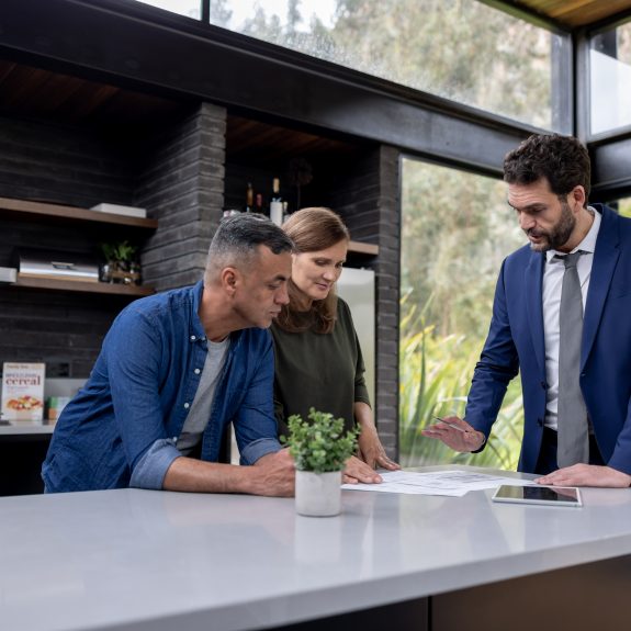 Financial advisor talking to a couple about their real estate investments